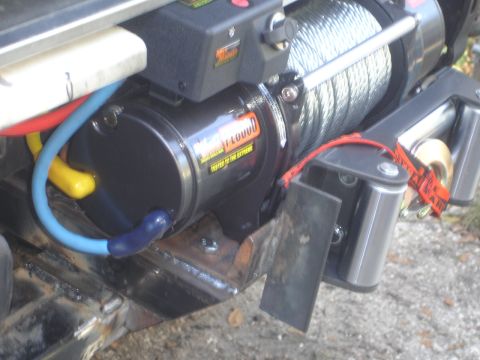 1989 Ford Bronco - Close-up of a WARN TF0000 winch and its mounting hardware.