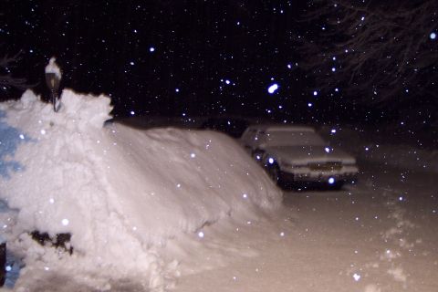 2001 Ford Crown Victoria - A 2001 Ford Crown Victoria sits covered in snow during a winter storm.