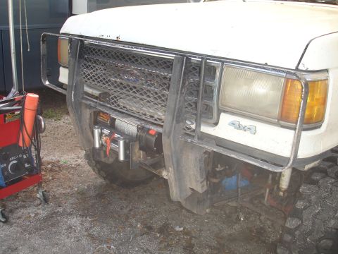 1989 Ford Bronco - Front view of a white Ford Bronco, likely from the late 1980s, equipped with a winch and brush guard.