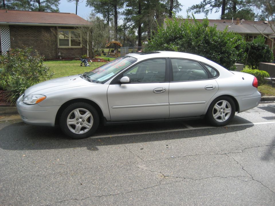 Silver 2001 Ford Taurus sedan parked curbside