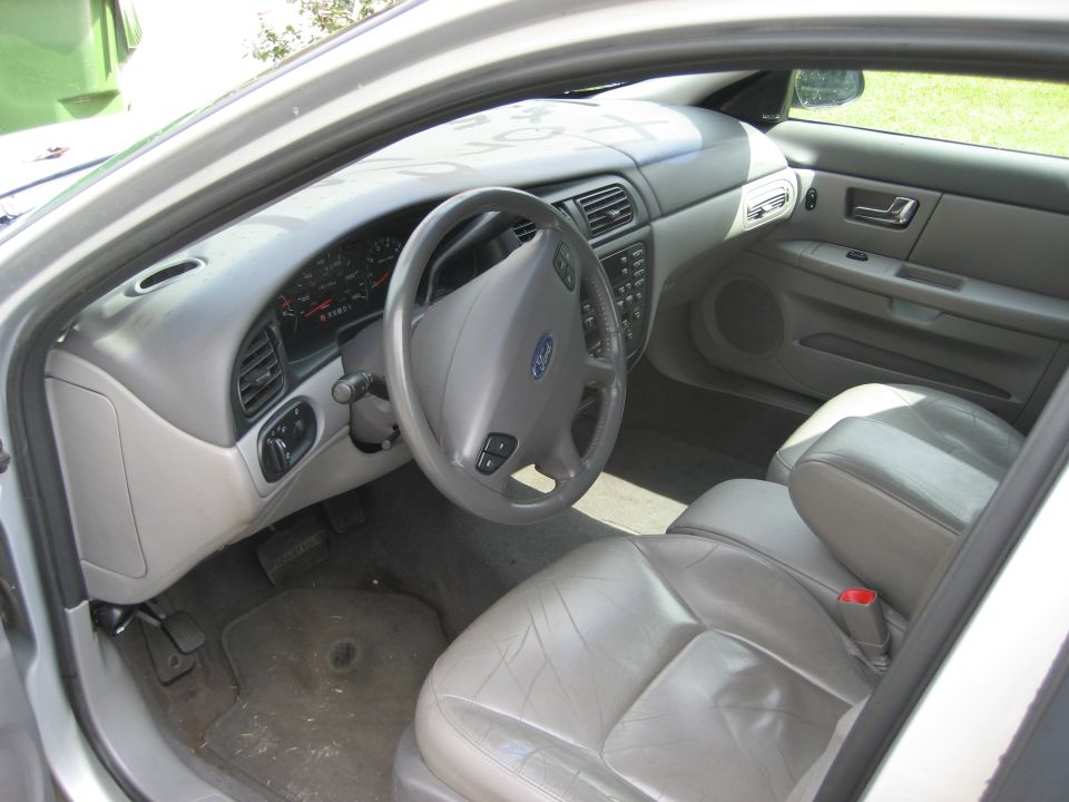 Interior of a 2001 Ford Taurus showing dashboard, steering wheel, and seats