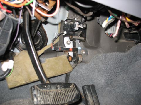 1995 Ford C-350 (Centurion Conversions) - The driver's side footwell shows the brake and accelerator pedals, along with various electrical connections.