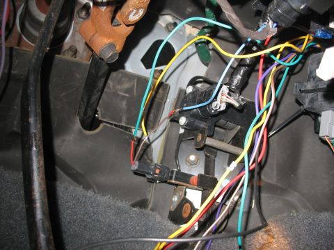 1995 Ford C-350 (Centurion Conversions) - A complex web of wires and electrical components are visible in the vehicle's interior, likely related to the dashboard or steering column.