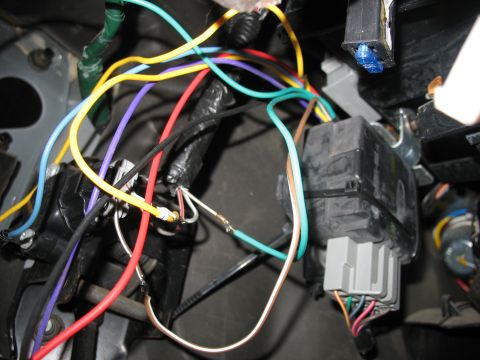 1995 Ford C-350 (Centurion Conversions) - A close-up view of a complex vehicle wiring harness, showing various colored wires connected to electrical components and a fuse.