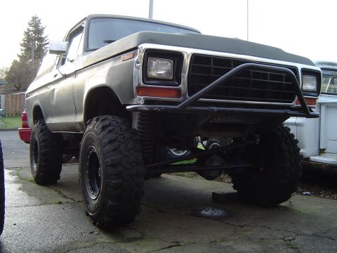 1989 Ford Bronco - This lifted 1978 Ford Bronco features a prominent aftermarket front bumper and aggressive off-road tires.