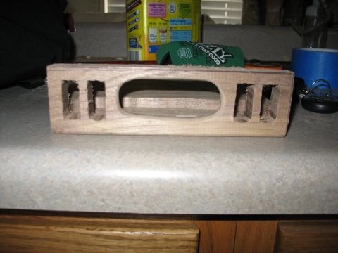 1995 Ford C-350 (Centurion Conversions) - A wooden part, possibly for an overhead console, sits on a countertop with various items in the background.