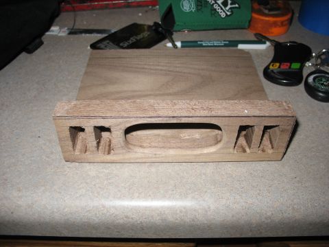 1995 Ford C-350 (Centurion Conversions) - A wooden part, possibly from an overhead console, with carved letters is shown on a countertop.