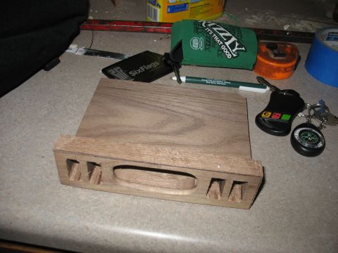 1995 Ford C-350 (Centurion Conversions) - A wooden part sits on a counter next to keys, a Six Flags tag, and a koozie.
