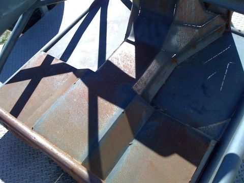 1994 Ford Bronco - Shadows play across weathered metal steps and structural framing.