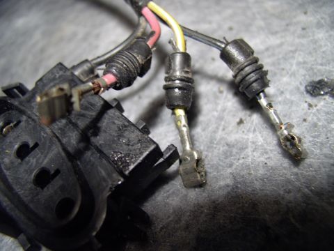 1990 Lincoln Town Car - One of the terminals plugged into the new connector. Note the rubber barbs that keep it weather proof. On the loose black wire note the tan…