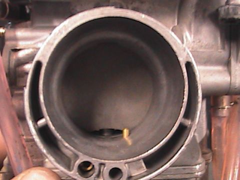 2007 Yamaha YZ450F - A close-up view inside a motorcycle carburetor, revealing its internal structure and components.