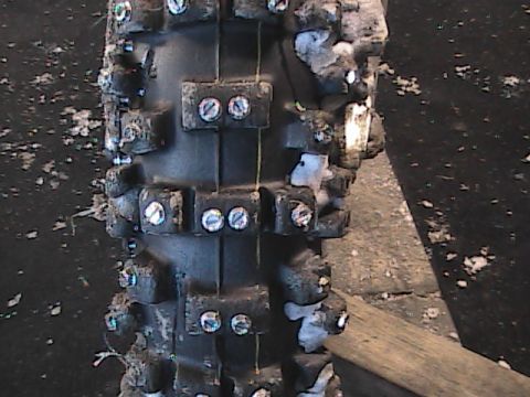 2007 Yamaha YZ450F - Studded dirt bike tire shown up close, possibly for ice racing conditions.