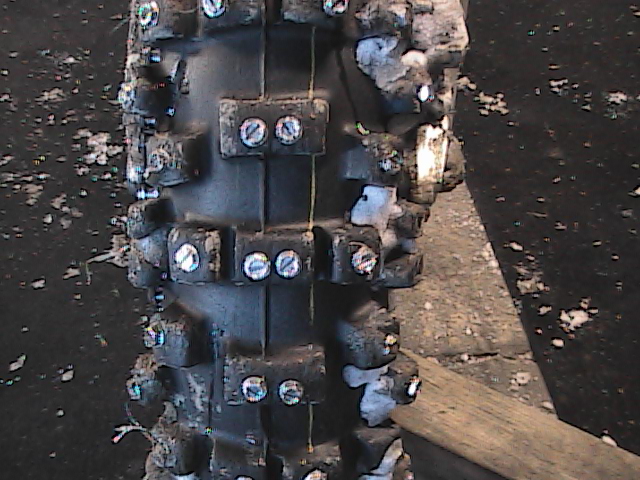 Close-up of a studded dirt bike tire, likely for ice racing