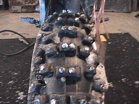 2007 Yamaha YZ450F - A close-up view of a knobby motorcycle tire fitted with metal studs for enhanced traction.