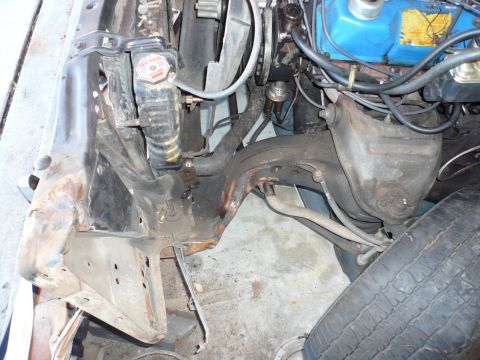 1975 Ford Ranchero - Close-up view of the engine bay, focusing on the radiator and front suspension components.