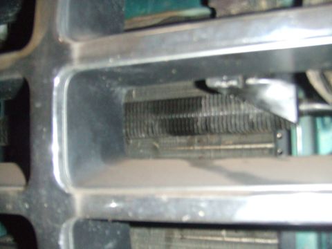 1996 Ford Bronco - Radiator visible through the front grille of a vehicle.