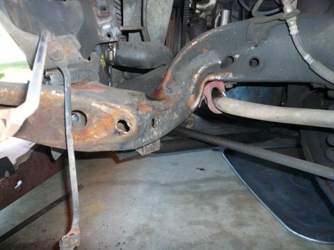 1975 Ford Ranchero - Close-up view of heavily rusted vehicle frame and suspension parts.