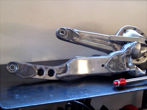 1996 Ford Bronco - Close-up of metallic automotive suspension parts, showing intricate metalwork and assembly points offthe-shelf hardware.