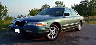 1996 Mercury Grand Marquis - This 1996 Mercury Grand Marquis is seen in a three-quarter front view, parked near a body of water.