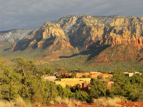 1983 Jeep CJ7 - Red rock mountains and desert vegetation surround a small town in Sedona, Arizona.