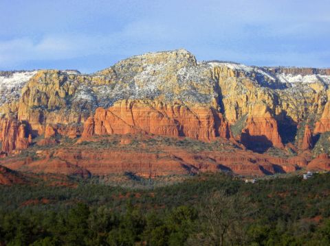 1983 Jeep CJ7 - Red rock formations in Sedona, Arizona, with snow on the upper slopes and pine trees in the foreground.