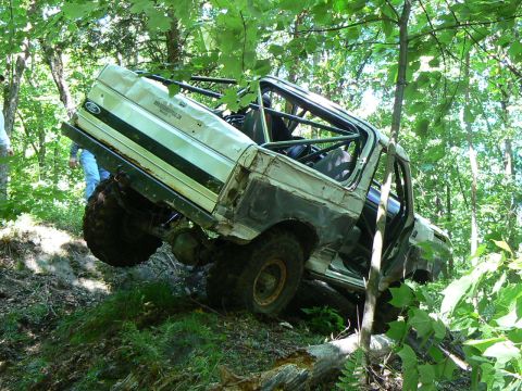 1995 Ford Bronco - This 1995 Ford Bronco is navigating a steep, wooded incline during an off-road excursion.