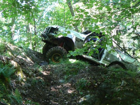 1995 Ford Bronco - This 1995 Ford Bronco is stuck on a steep, rocky incline surrounded by trees.