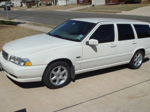 1998 Volvo V70 - A white Volvo V70 wagon is parked in a suburban driveway on a sunny day.