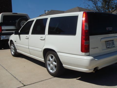 1998 Volvo V70 - A white 1998 Volvo V70 wagon is parked on a concrete driveway next to another vehicle.