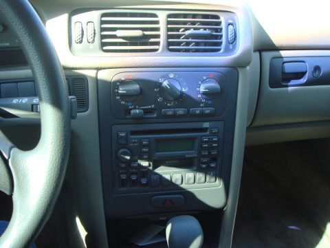 1998 Volvo V70 - Close-up of a car's dashboard, the center console with climate controls and audio system.