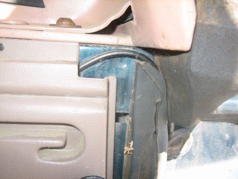 1995 Ford Bronco - Detail shot of the interior trim and a black wire running behind the dashboard.