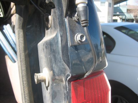 1995 Ford Bronco - Close-up of a vehicle's rear corner, showing a tail light and an antenna mount.