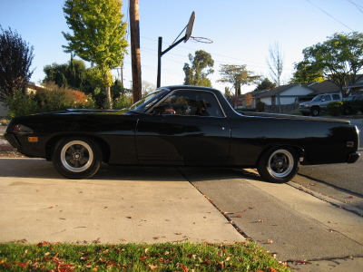 1970 Ford Ranchero - Side profile of a black 1970 Ford Ranchero with aftermarket wheels.