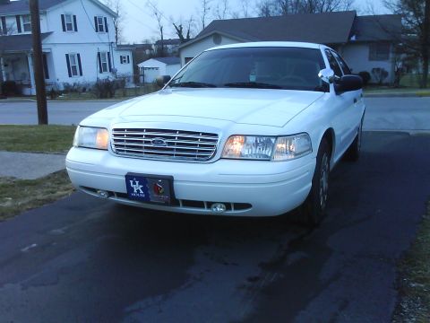 2003 Ford Crown Victoria - This white 2003 Ford Crown Victoria is shown from the front, its distinctive chrome grille and a license plate frame supporting the Kentuck…
