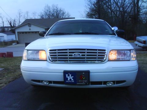 2003 Ford Crown Victoria - Front view of a white 2003 Ford Crown Victoria with a UK House license plate frame.