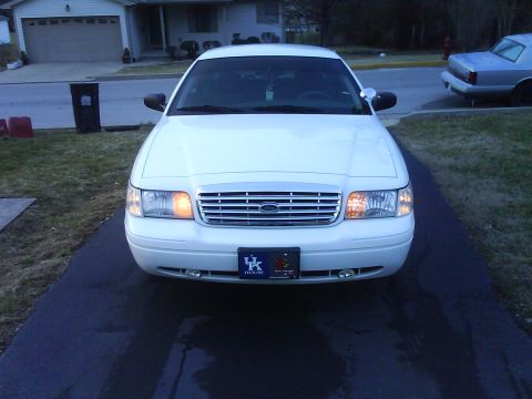 2003 Ford Crown Victoria - A white 2003 Ford Crown Victoria is shown from the front, parked in a residential driveway.