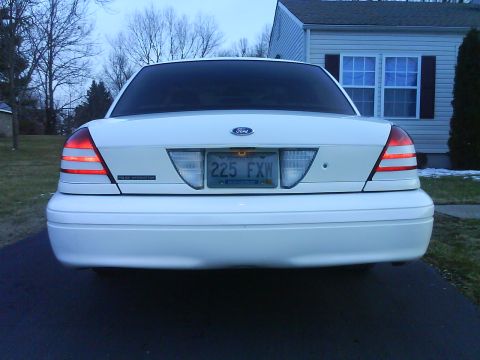 2003 Ford Crown Victoria - Rear view of a white 2003 Ford Crown Victoria sedan with license plate 225 FXW.