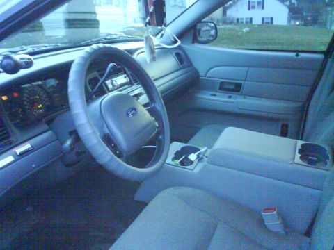 2003 Ford Crown Victoria - The interior of a 2003 Ford Crown Victoria, the steering wheel, dashboard, and center console.