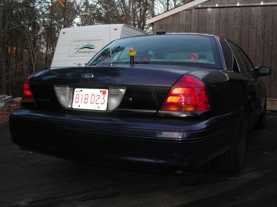 Dark 1998 Ford Crown Victoria rear view with license plate 81BD23