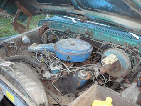 1978 Ford Bronco - The engine bay of a vehicle, showing the air cleaner, radiator, and brake booster.