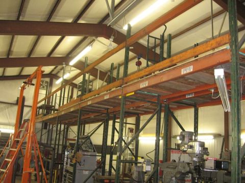 1986 Ford Ranger - Interior view of a warehouse with a multi-level mezzanine shelving system and various machinery.