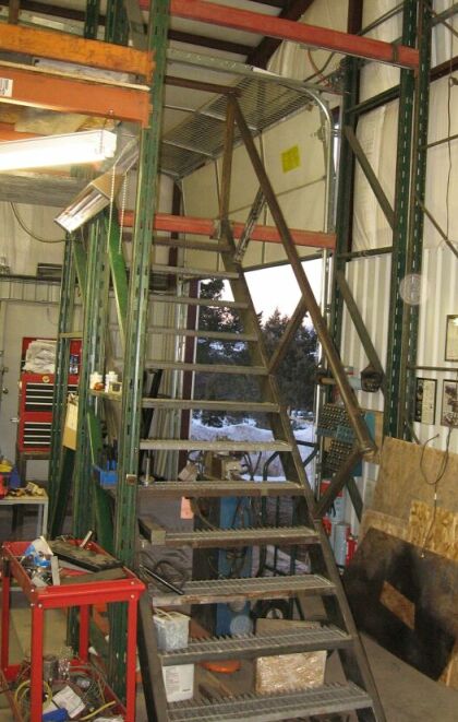 1986 Ford Ranger - Workshop interior with a metal staircase and storage shelving units.