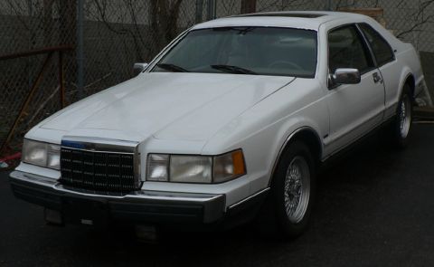 1990 Lincoln Mark VII - A white 1990 Lincoln Mark VII coupe is shown from a 3/4 front angle.