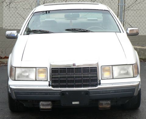 1990 Lincoln Mark VII - Front view of a white 1990 Lincoln Mark VII with its distinctive grille and headlights.