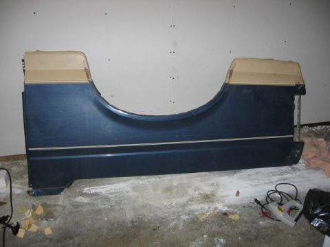 1989 Ford Bronco - This is a rear quarter panel from a 1989 Ford Bronco, showing its distinctive body lines and two-tone paint scheme.