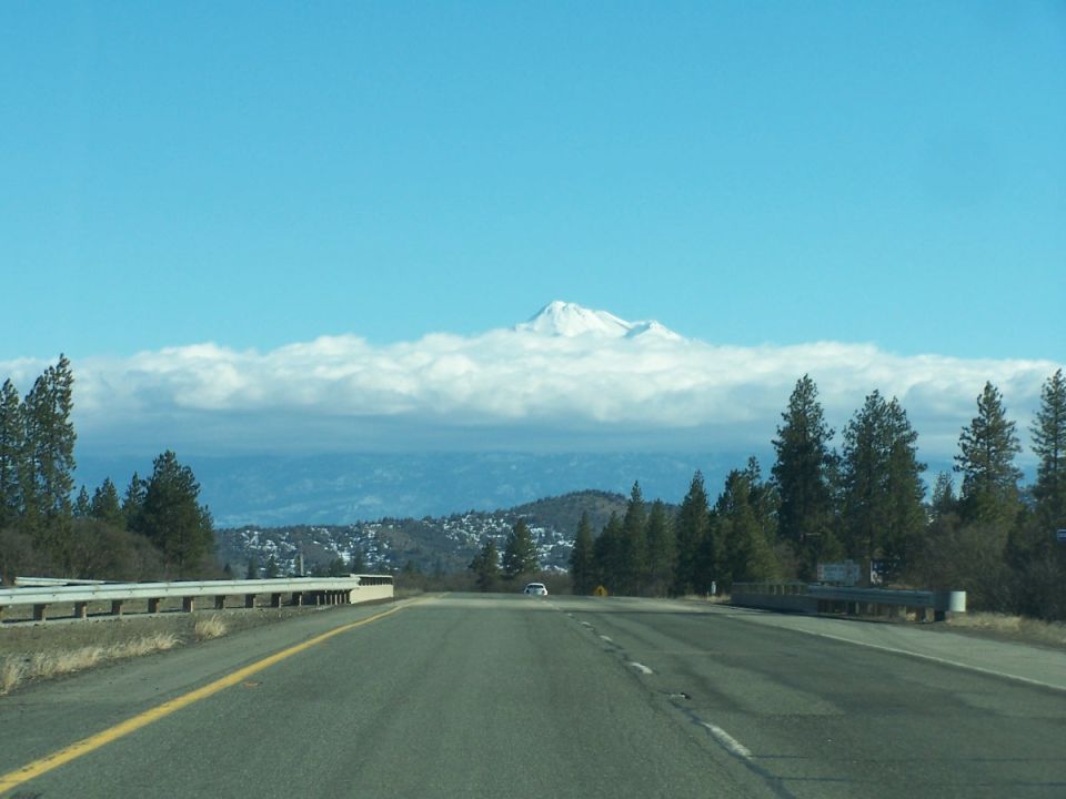 Snow-capped mountain peak viewed down a highway