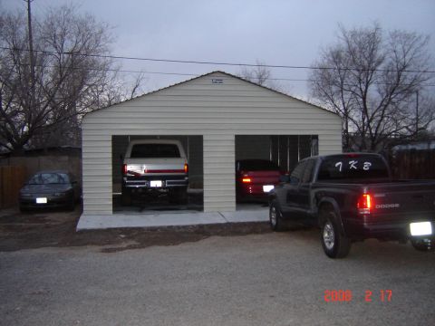 1988 Ford Bronco - A white pickup truck is parked inside a garage, with a red stripe across its tailgate.