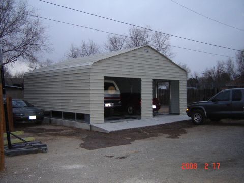 1988 Ford Bronco - A metal garage with multiple vehicles parked inside and outside. The date 2008-02-17 is visible in the lower right corner.
