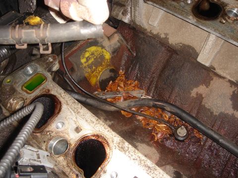 1998 Lincoln Town Car - Debris and coolant visible in the engine intake manifold area.