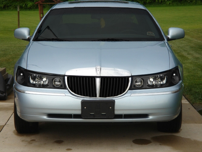 Front of a light blue Lincoln Town Car on a driveway